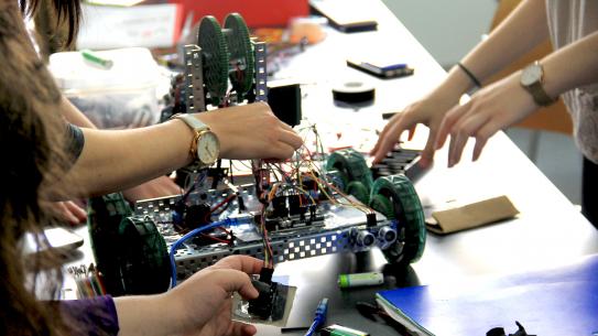 hands working on robot hands working on robot