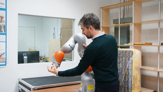 Professor Righetti working with robotic arm Professor Righetti working with robotic arm